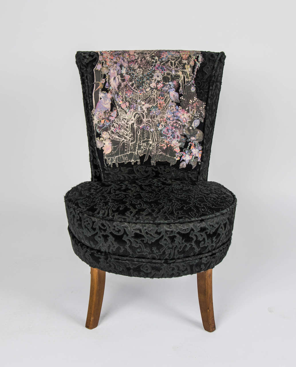 A unique 1946 small black 'Boudoir' chair. It has been revamped in a Rock and Roll style and re-upholstered with embossed pony skin, crystal and rhinestone detail.

Maker unknown.
