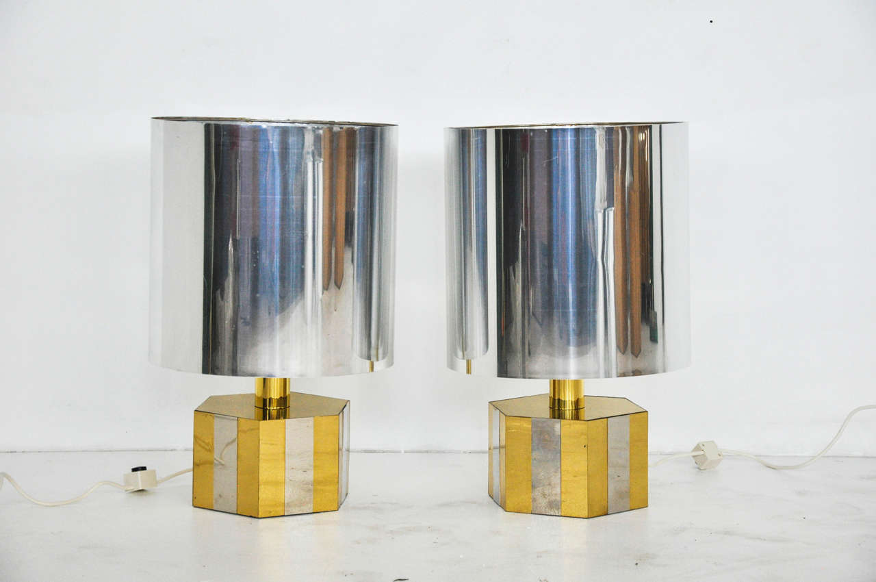Glamorous pair of Italian 1970s lamps. Brass and chrome with large chrome shades.