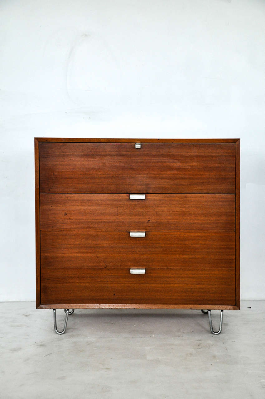 Drop front secretary desk designed by George Nelson for Herman Miller. All original walnut finish with aluminum pulls and hairpin legs.

Matching cabinet available.
