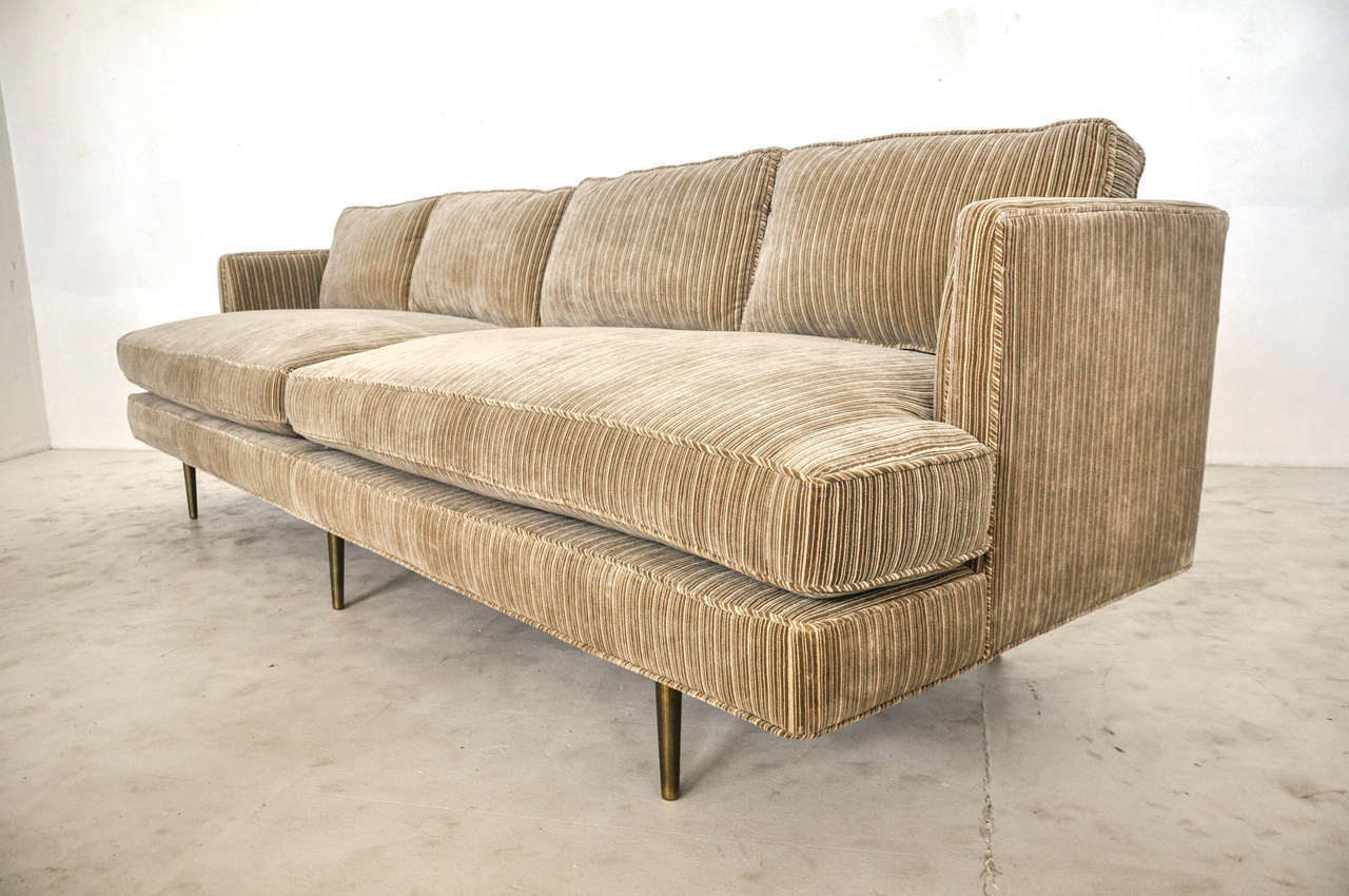 Sofa on brass legs designed by Edward Wormley for Dunbar. Measure: 9ft. Newly upholstered. Down cushions.