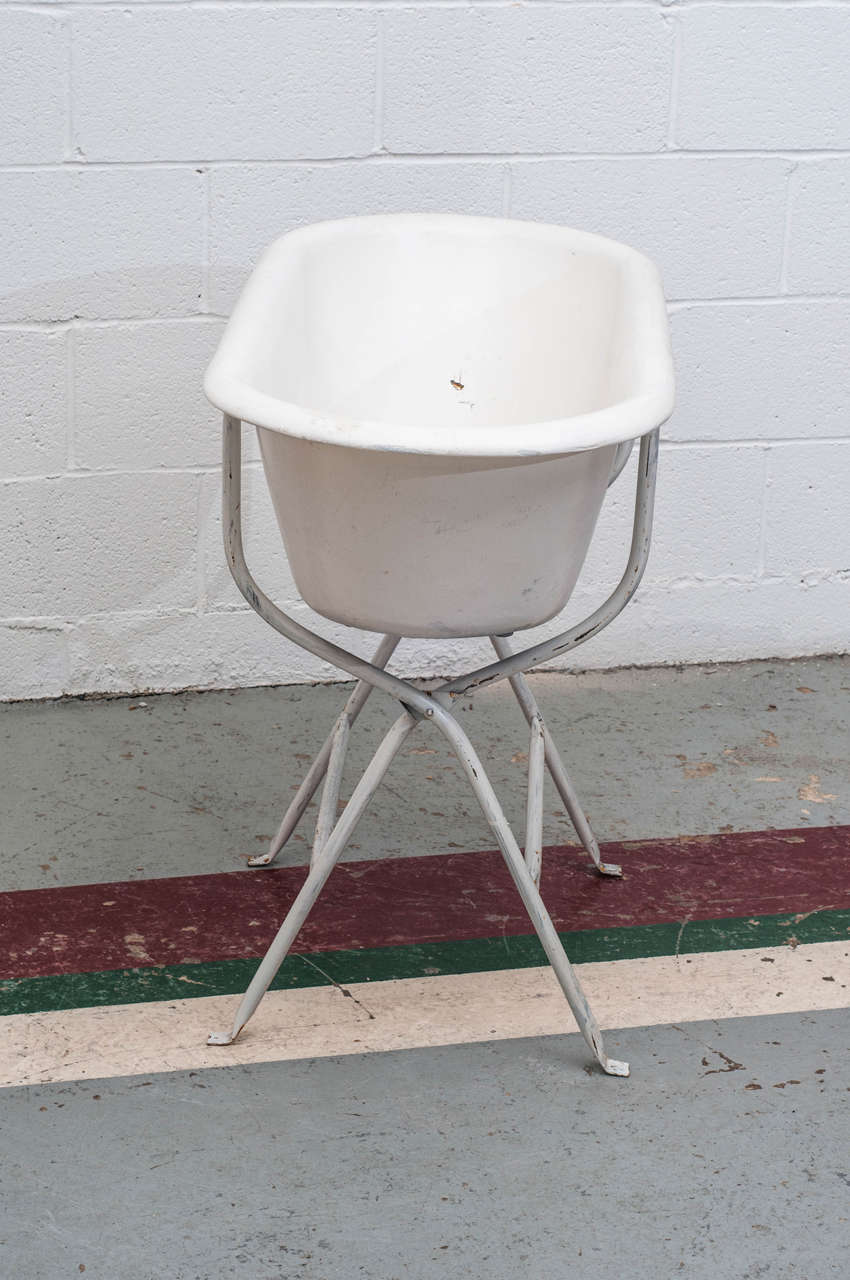 A vintage enamel baby bath on tubular stand. Great as a planter or as a wine and beer cooler at a summer party.