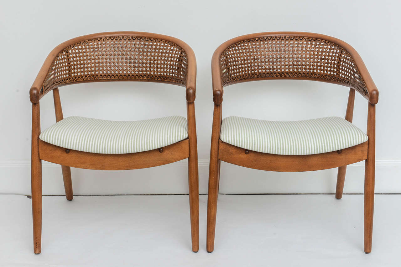 Pair of dramatic round backed lounge chairs most famously used by James Mont in one of his most notable commissions, the King Cole Penthouse in Miami. They feature a beautiful handwoven cane seatback. 

Excellent condition and reupholstered in a