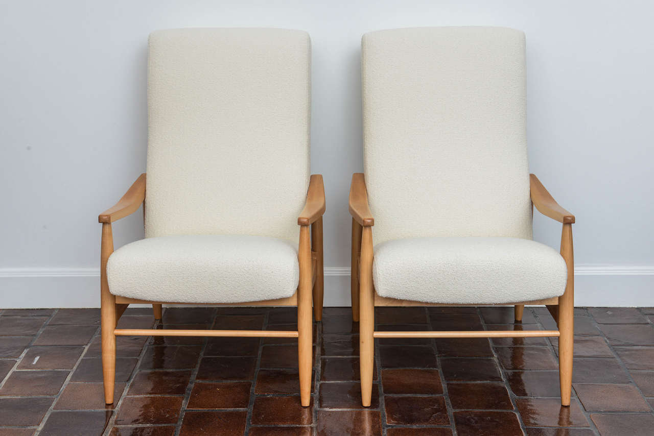 Handsome pair of 1960s Milo Baughman Teak Recliners. Reupholstered in classic knoll bouclé́ in a soft ivory tone. Supremely comfortable and stylish.