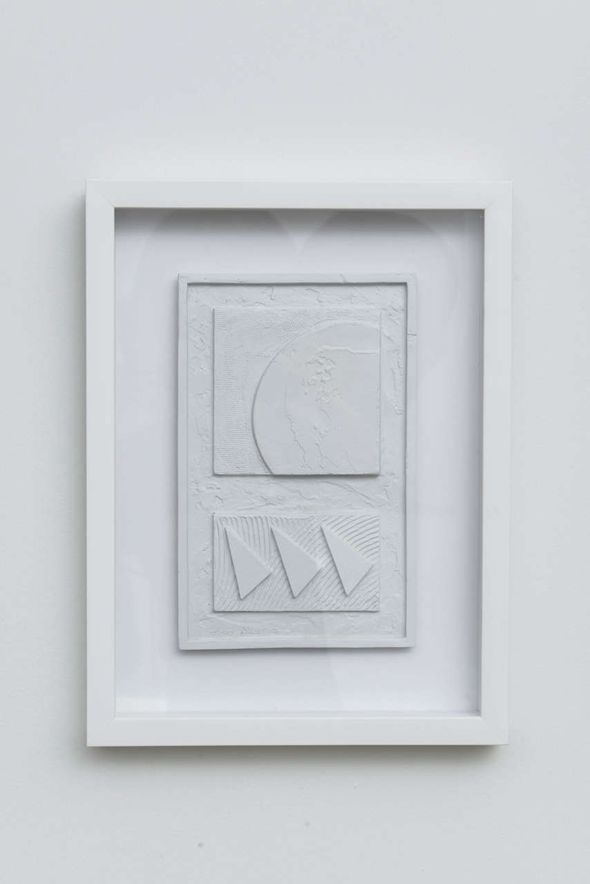 A fun, geometric, plastered wall relief framed with shadowbox.

White matte plaster finish. 

Two available, priced and shown individually.