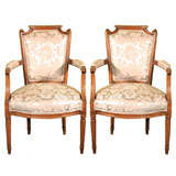 A Pair of Louis XVI Period Walnut Arm Chairs
