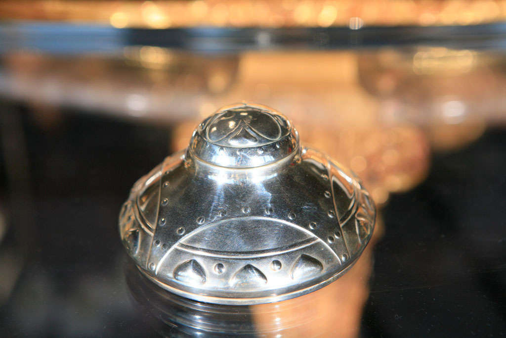 A Secessionist WMF Inkwell featuring a rivet design and geometric hearts. Comes with a glass inkwell which may not be original but fits pefectly into the ink receptacle. Marked with the WMF logo (see last photo).