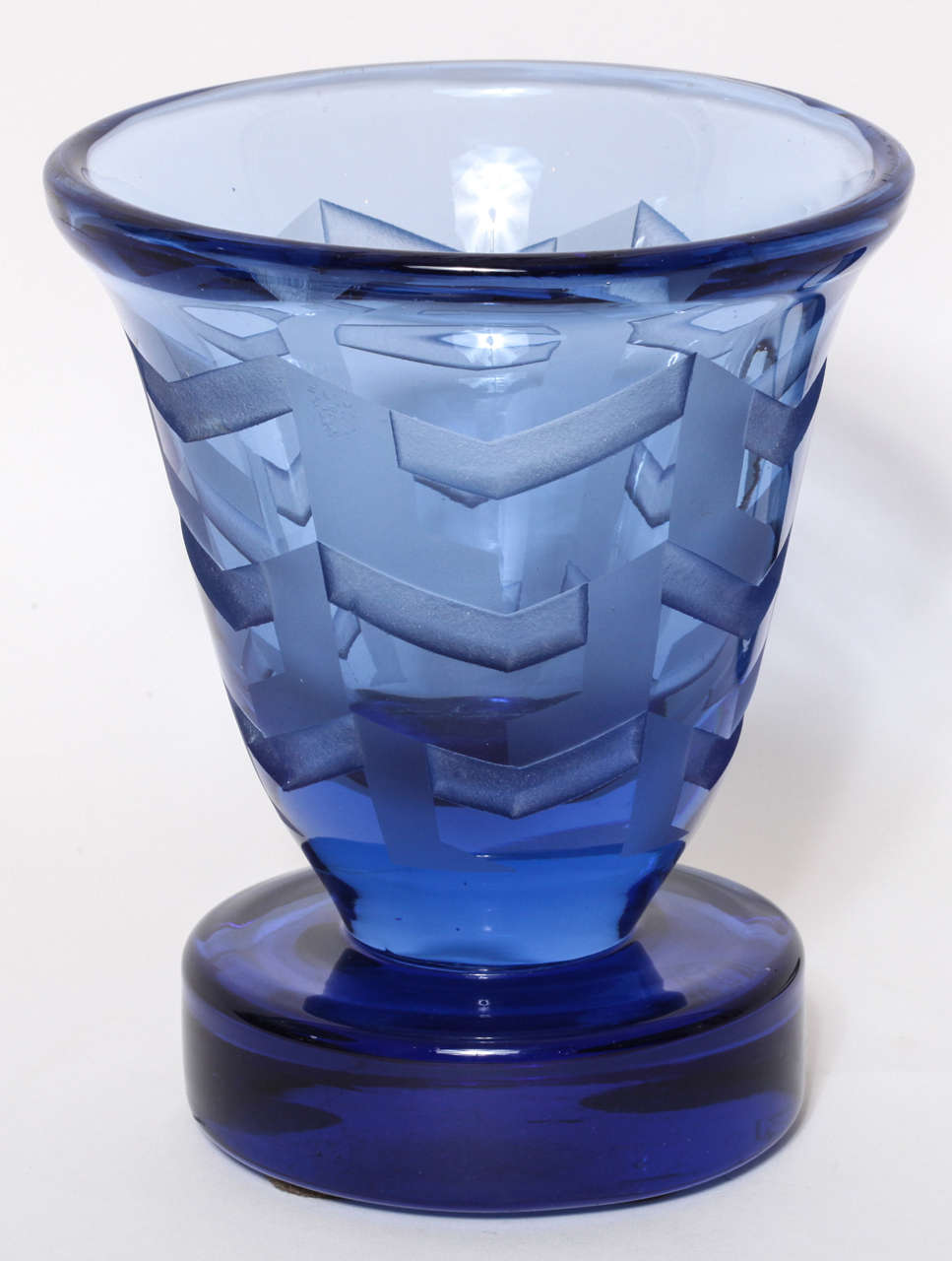 Blue glass vase has acid etched geometric designs by Jean Luce (1895-1964), Paris.
Signed: artist's monogram

Jean Luce worked as a designer in a cubist-inspired style, rejecting the use of too much design and figurativeness in decoration. He