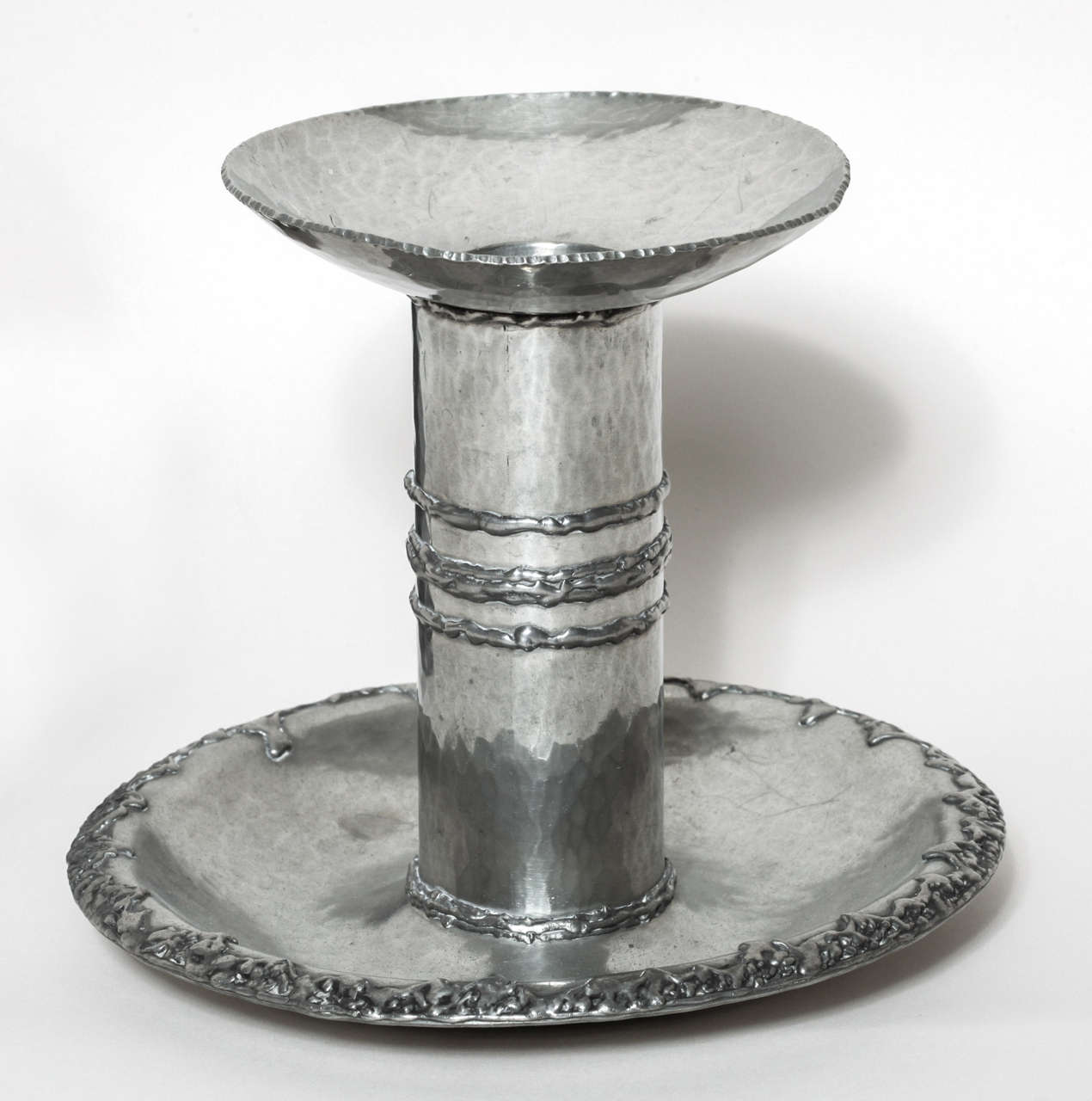 Handwrought dinanderie pewter martele´candle holder with applied metal around the rim and body.
Signed: R. Delavan on body. 
Stamped: R DELAVAN/ DECORATEUR/ PARIS/ DEPOSE/ ETAIN D'ART/ TRAVAIL AU MARTEAU on underside.

*Variety of other available