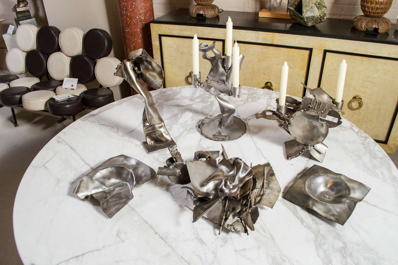A unique grouping of six, creative, welded and molded sculptures in stainless steel by Albert Feraud (1921-2008) France circa 1970s - Signed - A. Feraud - Priced separately.

A fifteen inch-high, abstract, curvilinear candelabra, sculpted in
