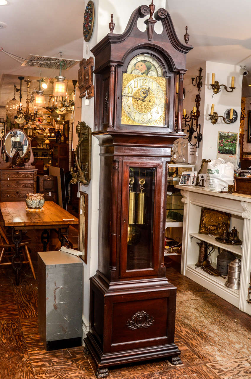 This English clock is made by J.J. Elliot circa 1915. 

This antique grandfather clock is a robust J.J.Elliot retailed by Tiffany & Co., New York.  Non-tubular  It chimes on the hour and every half hour.  It has a high ballast and runs very