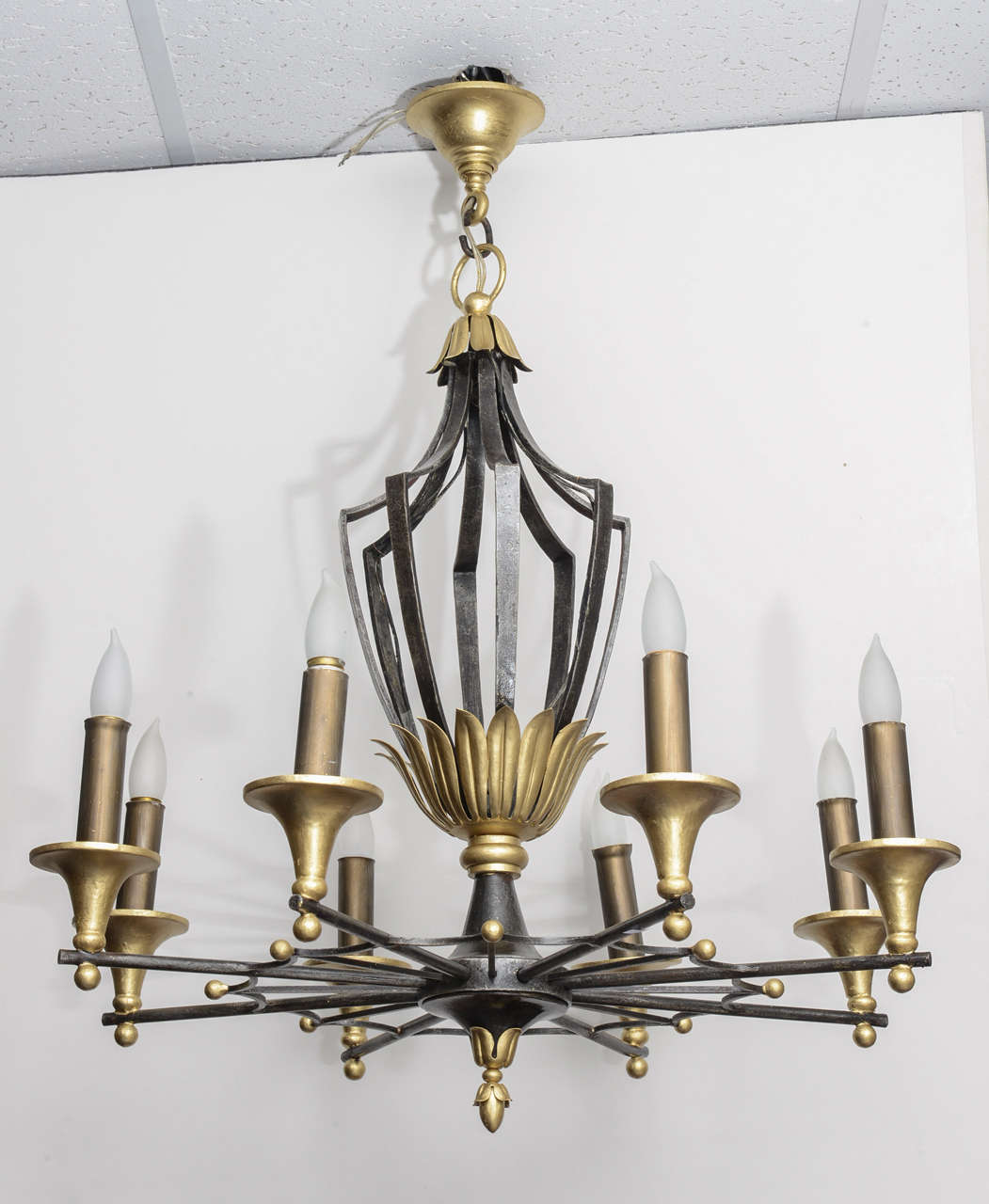 Wrought iron chandelier in the perfect neo classical style. (Circa 1940 )
Very sophisticated design, by a talented iron worker.
16 rays coming from the central part of the piece, sumounted by a vegetal crown supporting a classicalbaluster