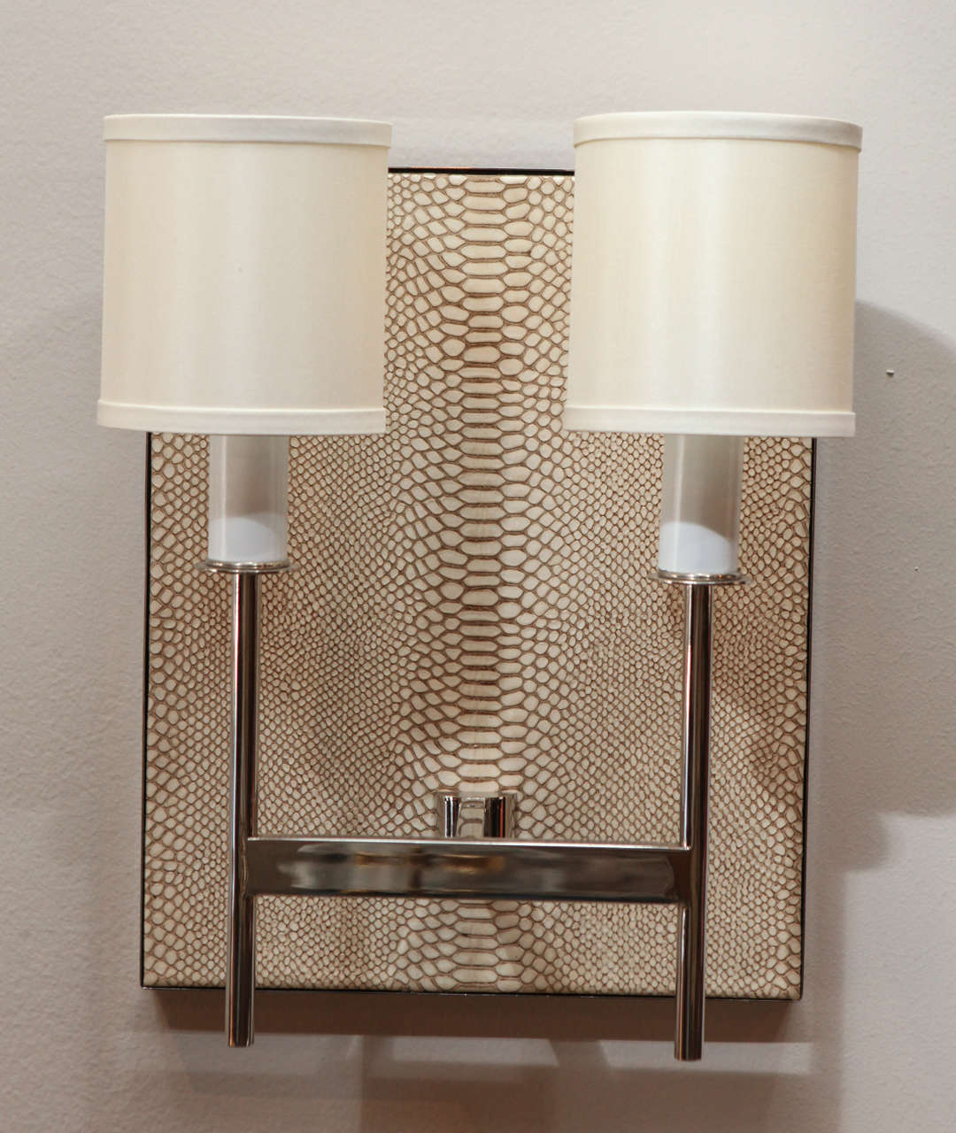 Modern Paul Marra Two-Arm Sconce with faux python back. Polished nickel, no lacquer. Shade is Vanilla silk pongee (or specify). Faux python. By order.
