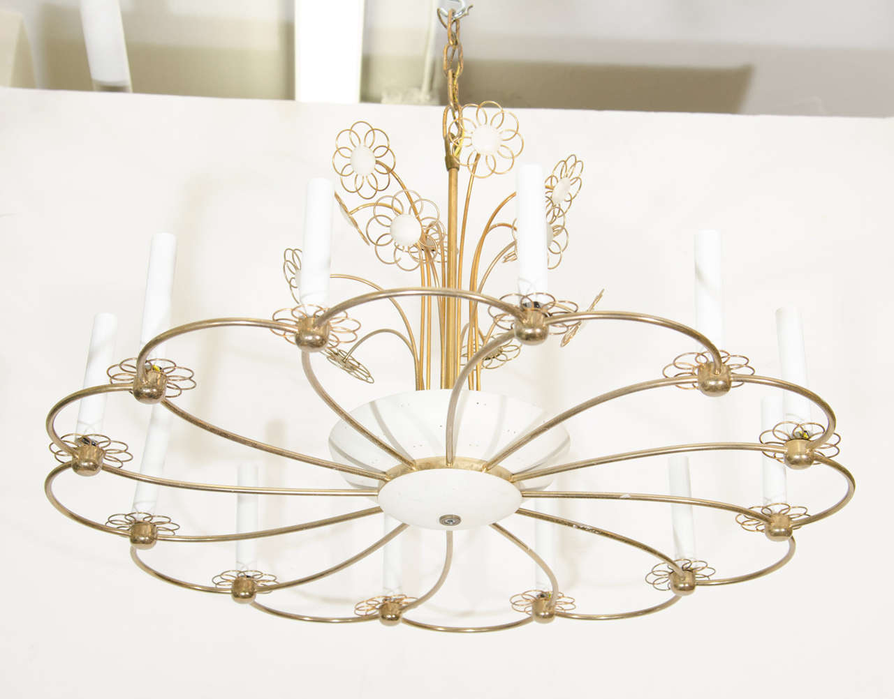 A vintage brass and enamel daisy shaped chandelier in the style of Paavo Tynell for Lightolier. The chandelier has 12 candelabra sleeves. 

Good vintage condition with age appropriate wear.  Some scratches

Reduced from: $3,950