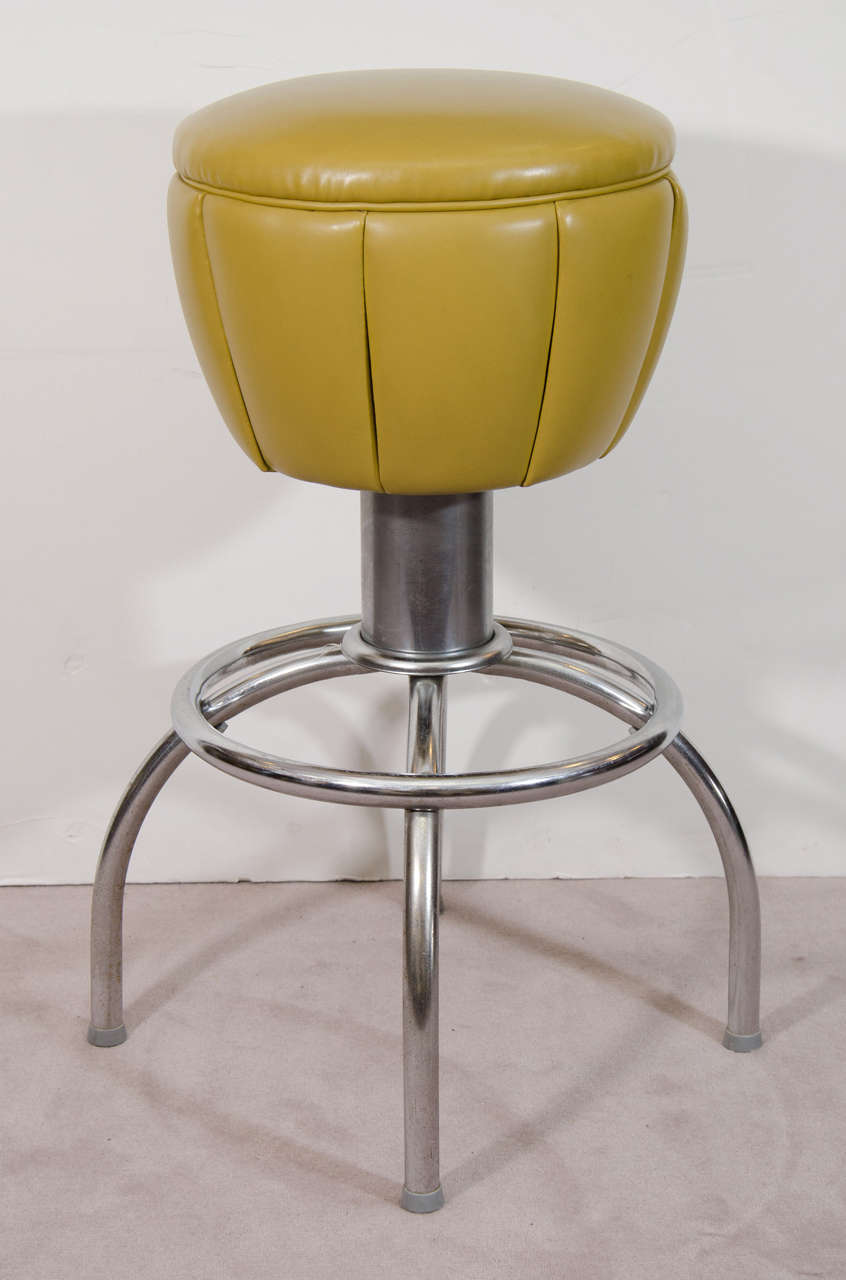 A vintage pair of 1950's swivel bar stools with adjustable chrome bases. Original vinyl olive green upholstery. 

Good vintage condition with age appropriate wear.

Reduced from: $975