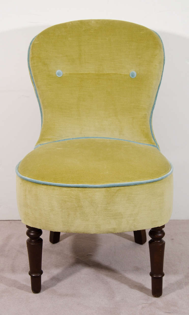 A pair of Victorian petite fireside armless chairs with wooden legs. Newly upholstered in green velvet with blue trim and two blue buttons on each back.

Reduced from: $2,750