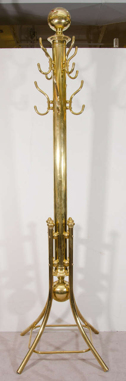 A 19th century heavy brass coat rack with eight double hooks. Recently polished.