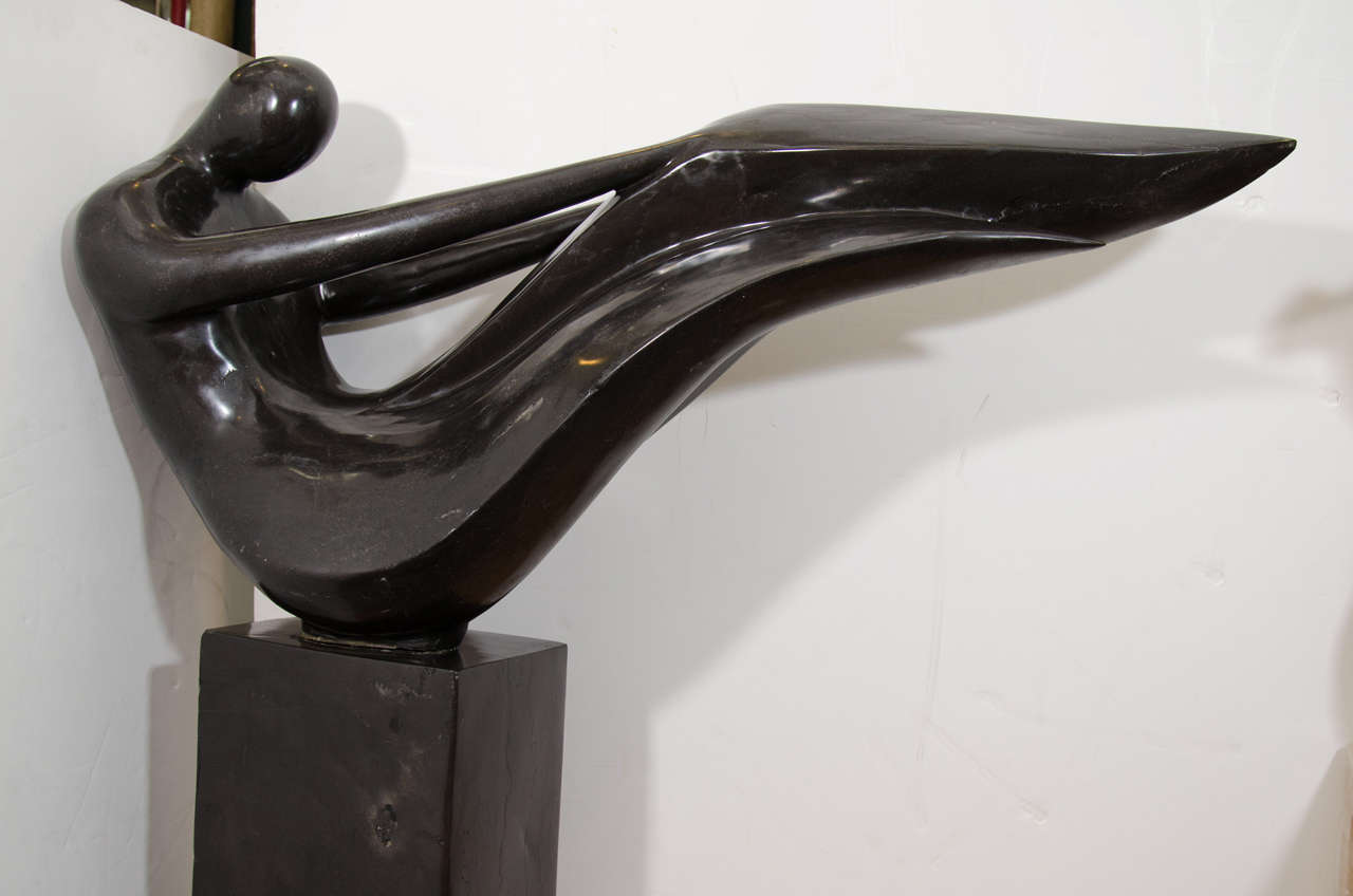 An impressive, vintage, abstract, solid, black marble figural sculpture on a pedestal base after Henry Moore.

Good vintage condition with age appropriate wear. More pronounced around the edge of the sculpture.