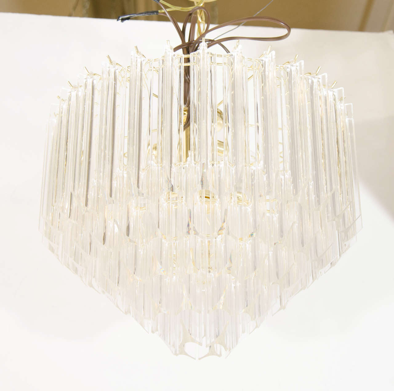 A vintage pair of five-tier chandeliers with Lucite rods suspended from a brass frame.

Good vintage condition with age appropriate wear

$1,150 EACH