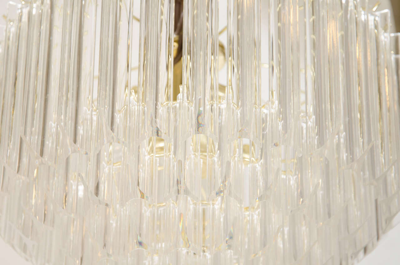 A Midcentury Pair of Brass and Lucite Five-Tier Chandeliers In Good Condition In New York, NY