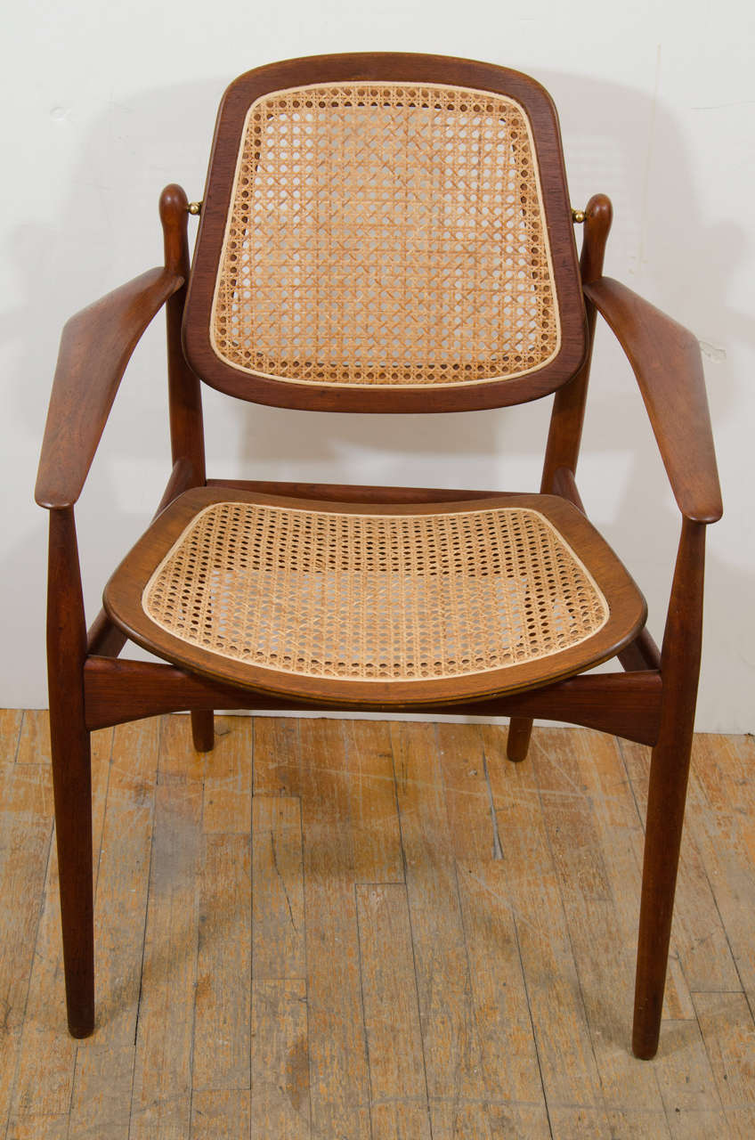 A vintage Arne Vodder teak and cane armchair. The back panel tilts forward and backward.

Reduced from: $1000