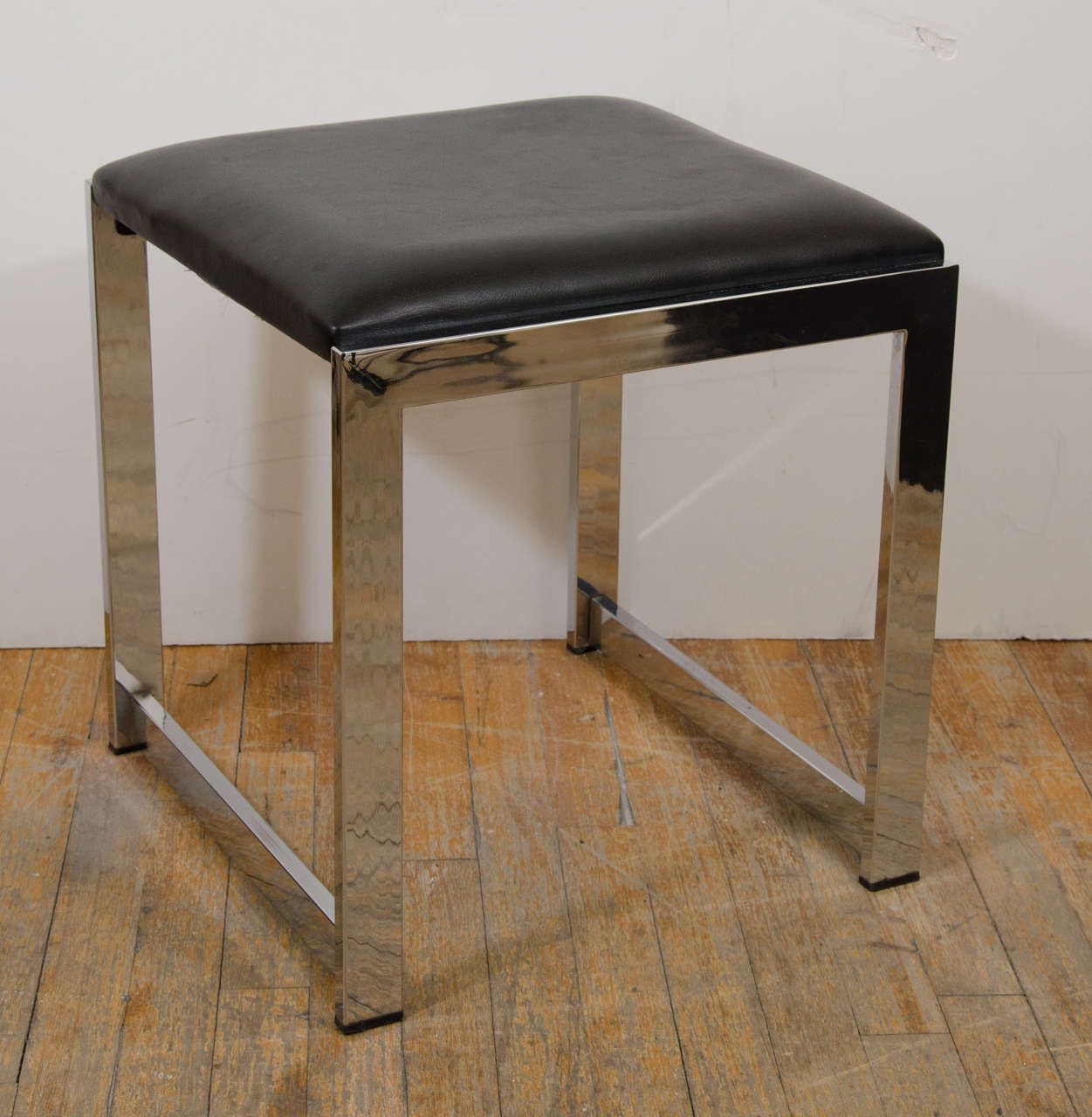 A vintage black vinyl bench or stool with chrome frame

Good vintage condition with age appropriate wear. Some scratches to the chrome.