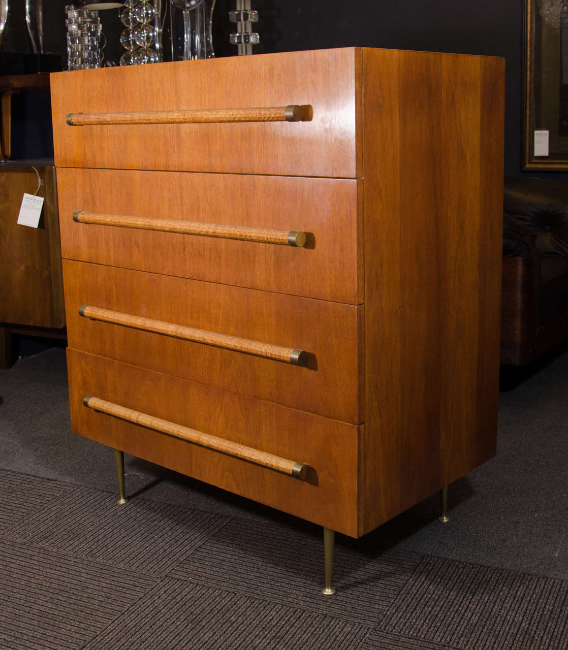 A vintage T.H. Robsjohn-Gibbings four-drawer dresser in walnut with weaved wicker covering drawer pulls, brass legs and hardware.

Reduced from: $5000