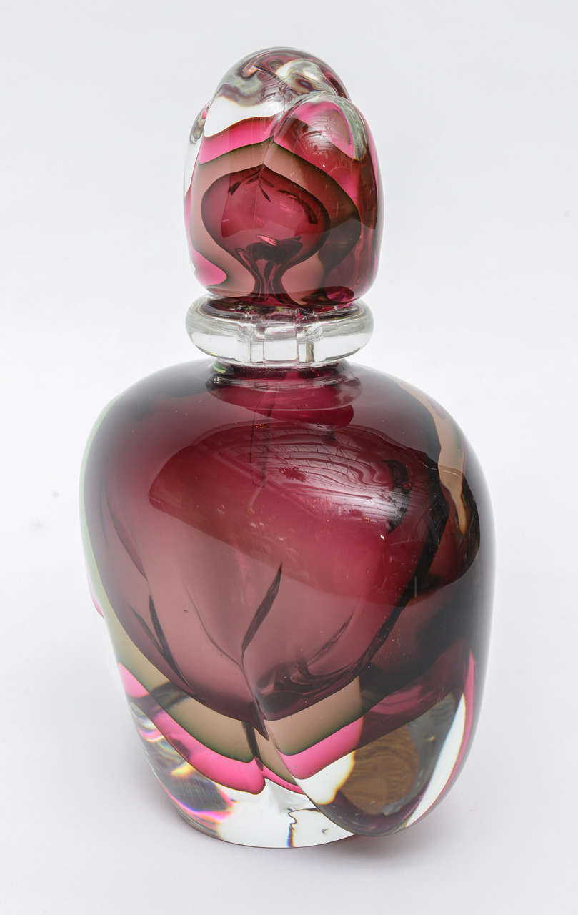 Large sommerso perfume bottle in gorgeous tones of raspberry, mauve,and garnet suspended in clear Murano glass.