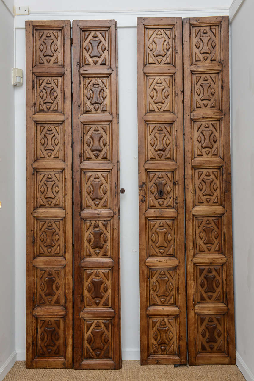 Four carved folding panels with original hardware. Measurements given are for each panel