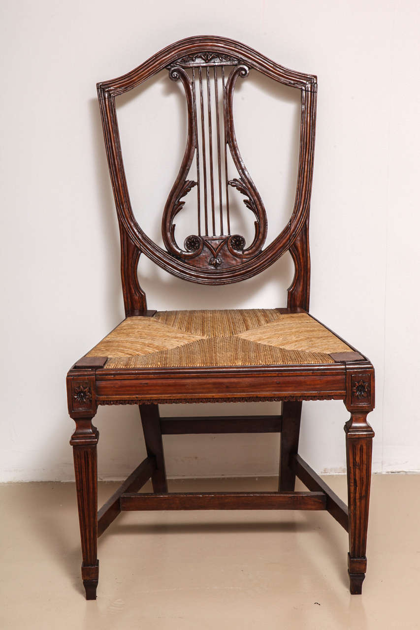 Set of five Italian neoclassical walnut, lyre back side chairs, with woven rush seats.