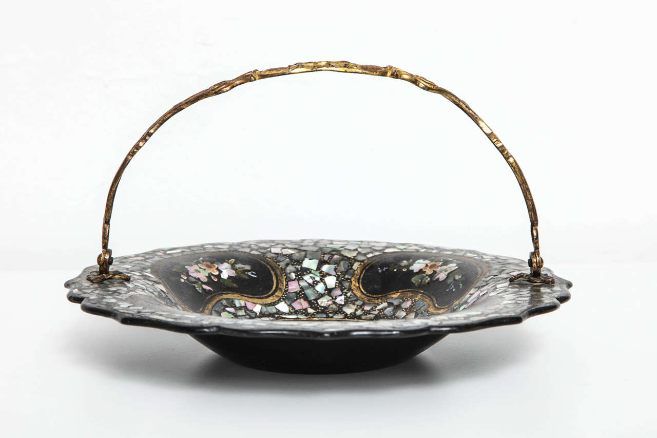 Victorian mother-of-pearl inlaid papier mâché basket with lacquered brass handle. Elaborately inlaid with floral decoration and scalloped edge.
