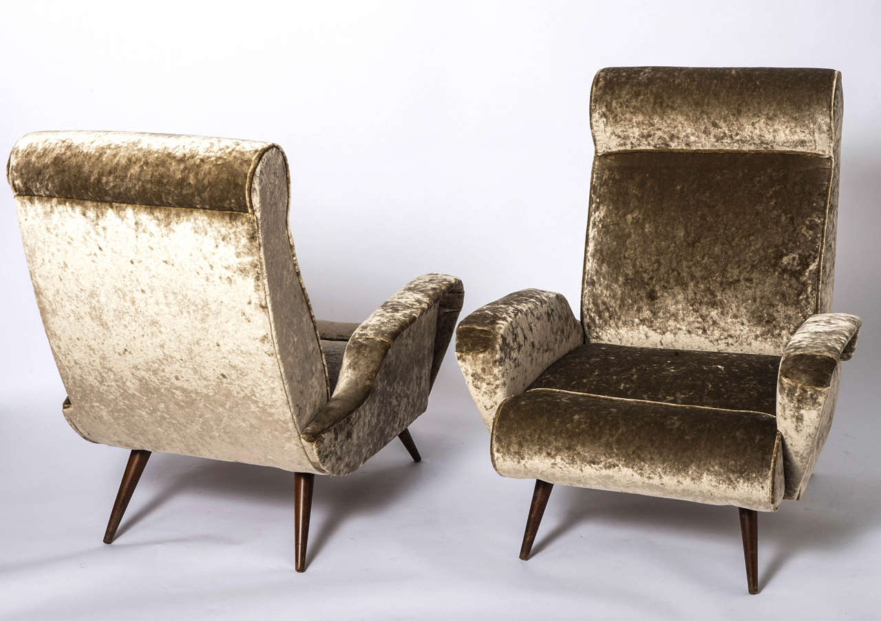 A pair of armchairs in the style of Marco Zanuso.
Of elegant sculptural form.
On tapering stained beech legs.
Covered in new taupe colored velvet,
Italian,
circa 1950.
Measures: 92cms H x 77cms W x 74cms D.