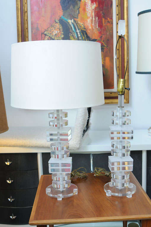 Stacked Lucite table lamps in superb condition.
Very unique lamp. Made of lucite, with clear lucite disks and rectangular prisms stacked in layers. Thin sheets of frosted lucite sandwich the rectangular prisms to accentuate the piece.