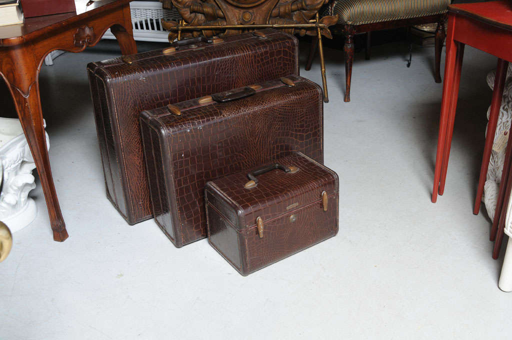 Three piece set of faux crocodile luggage.