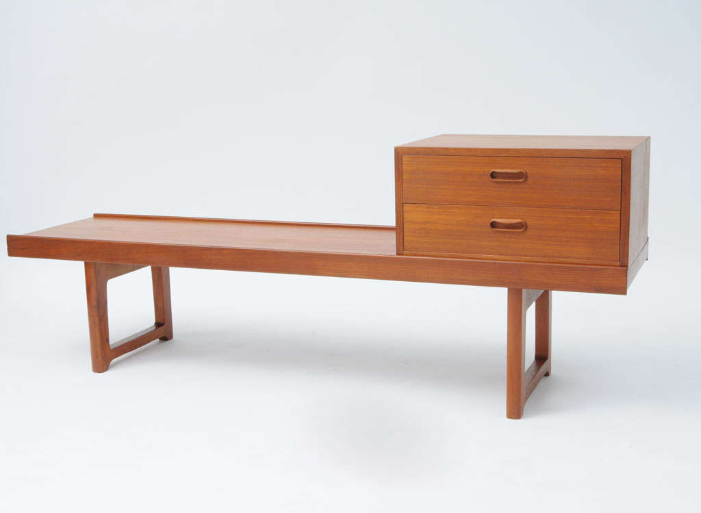 Compact bench or sofa table in solid teak wood with a raised border and detachable cabinet. The cabinet has two drawers and can be placed anywhere on the table for versatility. Fully labeled with maker and manufacturer marks.

PLEASE NOTE: We