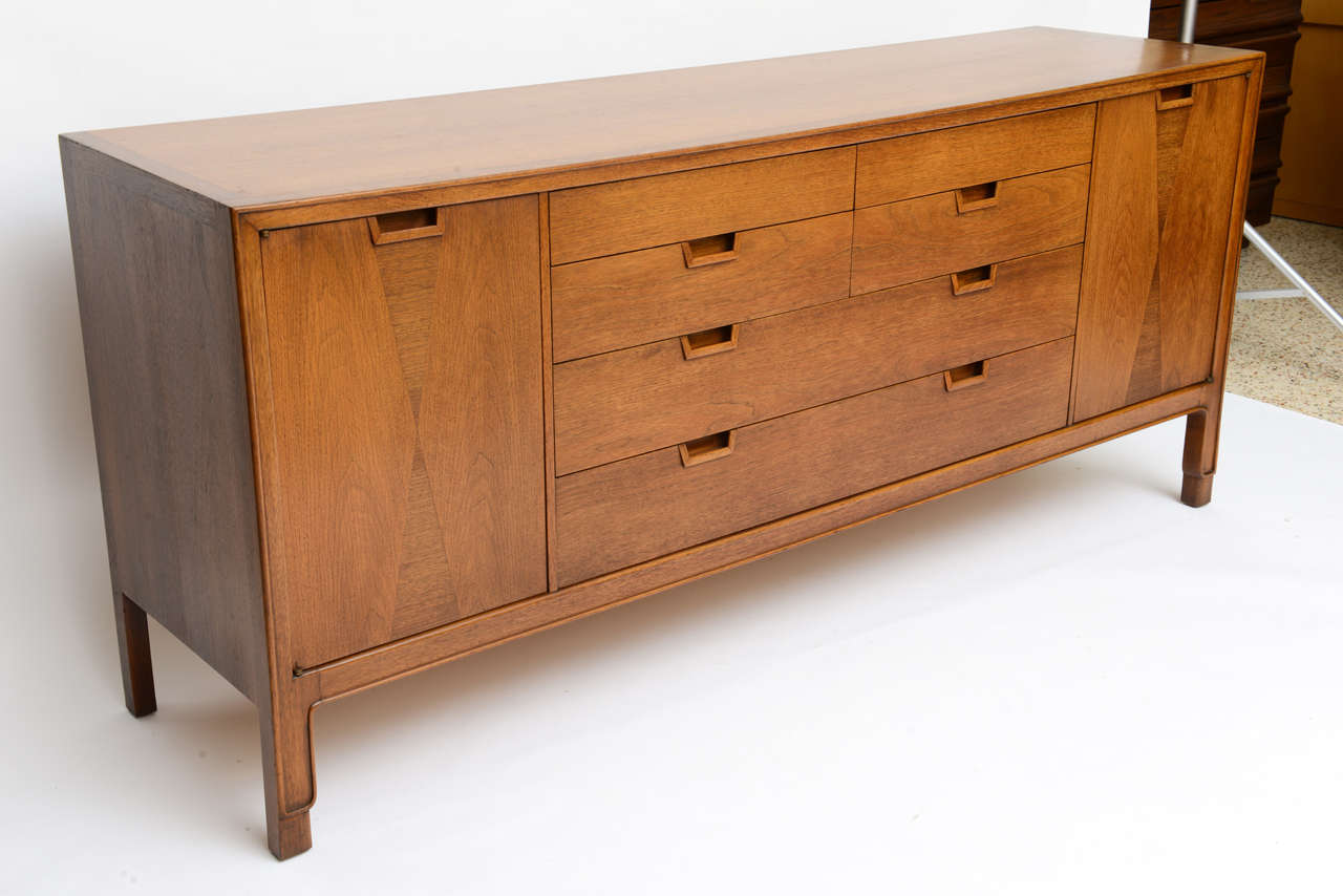 SOLD John Stuart Janus Collection  dresser in beautiful walnut with harlequin inspired inlays. Bountiful storage behind side doors opening to reveal eight drawers.  The center with  six center drawers, two long and four short. Note the oriental