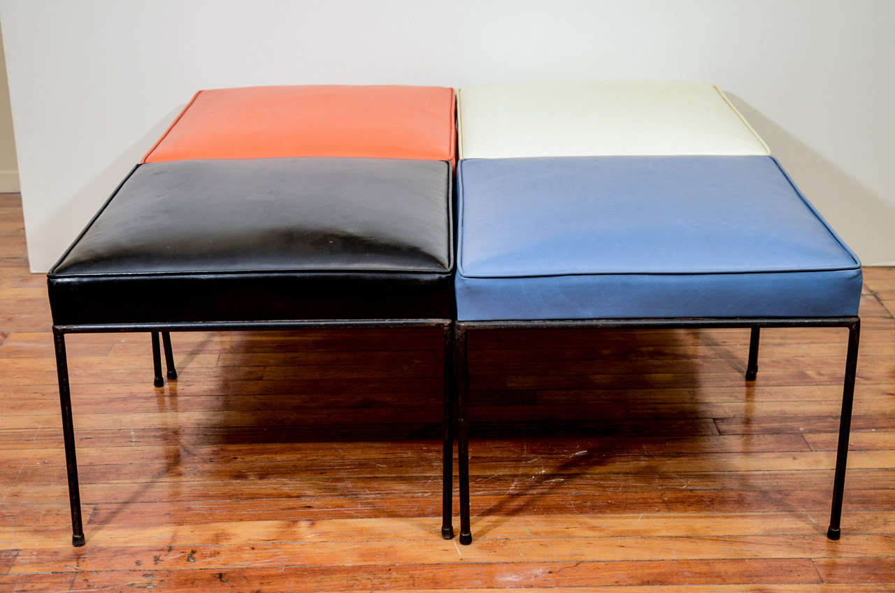 A vintage set of four square benches with iron legs in original black, blue, orange, and white vinyl. They are by noted designer Paul McCobb.

Reduced from:  $5,000