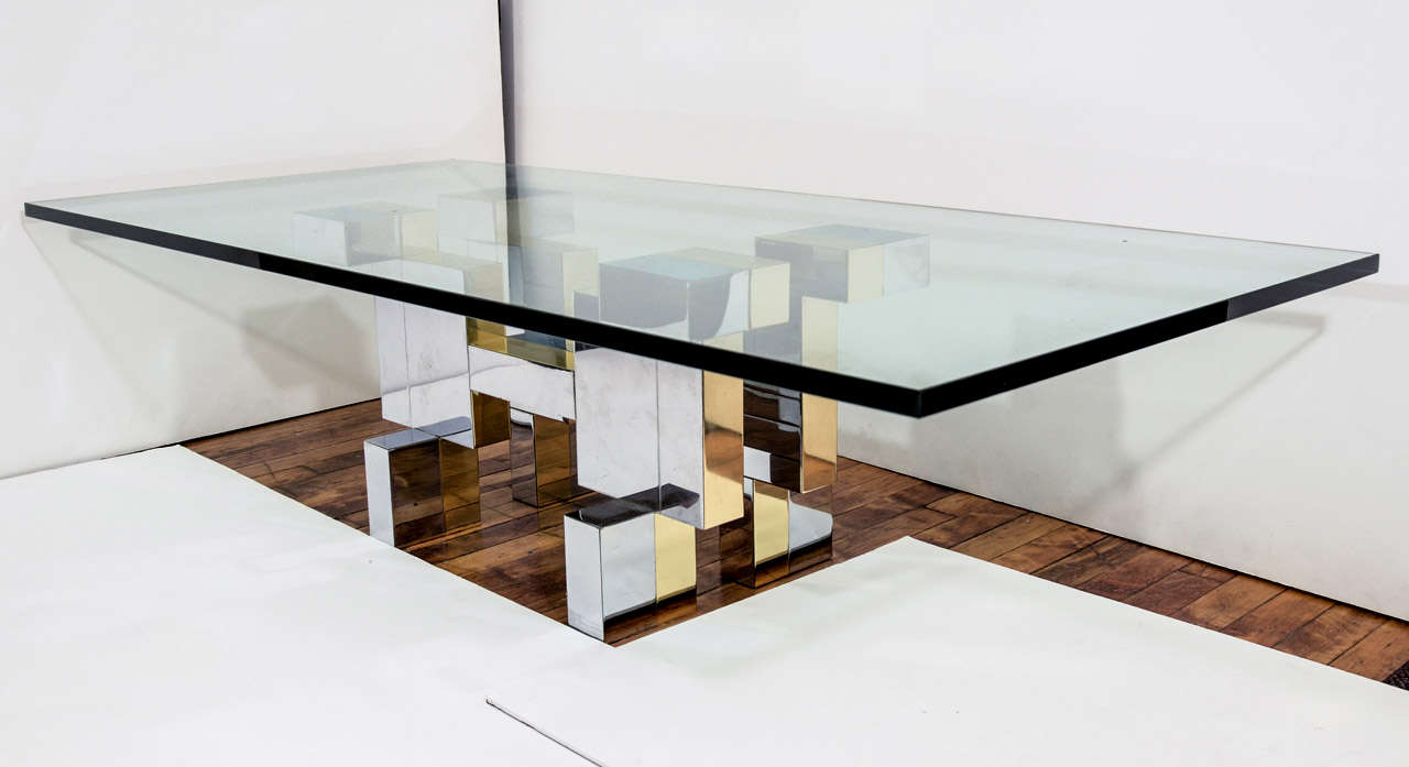 A vintage Cityscape coffee or cocktail table by noted designer Paul Evans.  The table has a thick glass top and an abstract base made of chrome and brass.