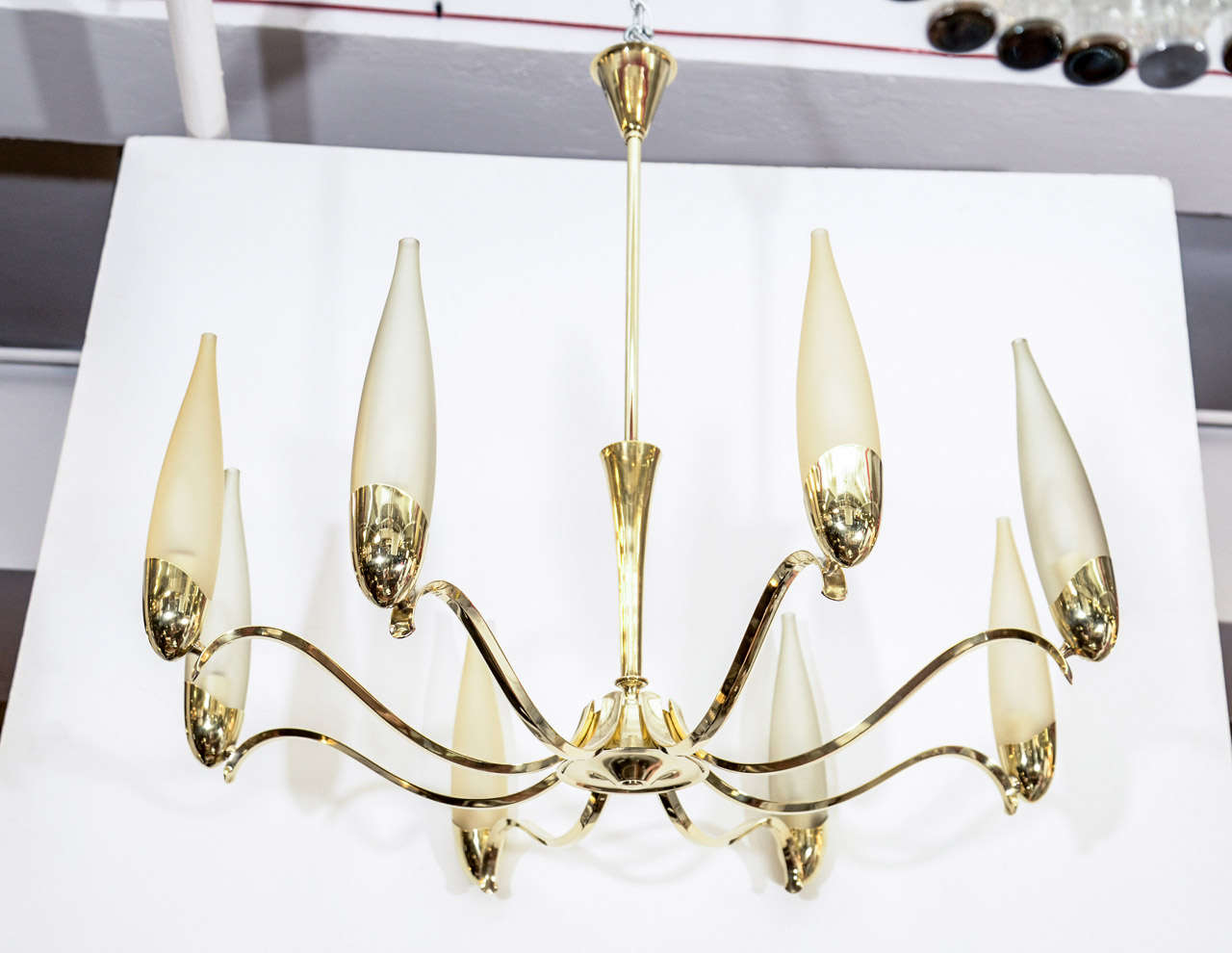 A vintage Italian chandelier with a brass body and eight opaline glass shades attributed to Stilnovo, circa 1958.