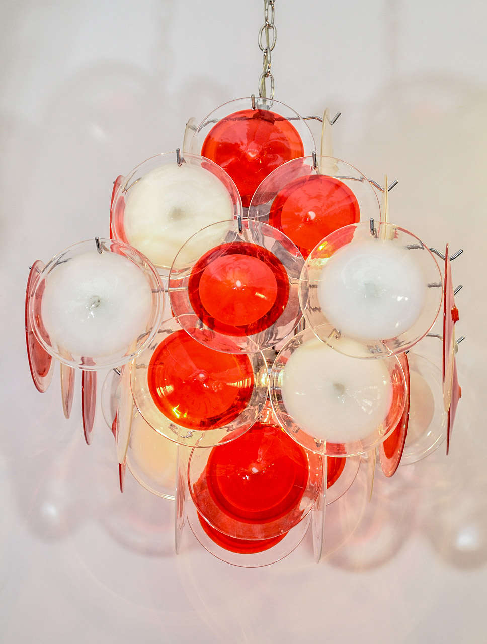 A vintage Vistosi chandelier with four tiers of alternating bright orange and white handblown glass discs on a chrome fixture.

Reduced from: $7,800