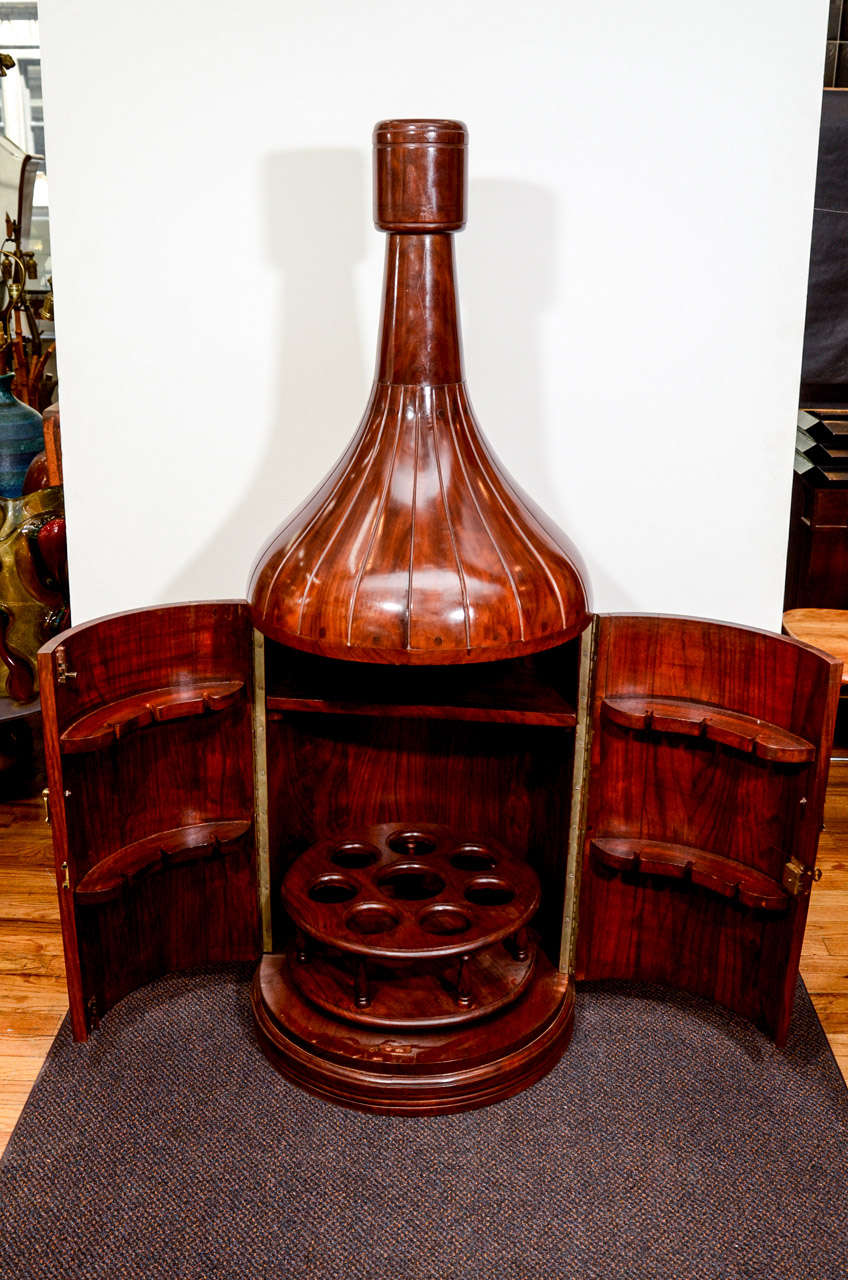 A vintage mahogany and bronze inlay champagne bottle bar with lock and key. Great
conversation piece as well as a functional storage bar for champagne bottles and glassware.