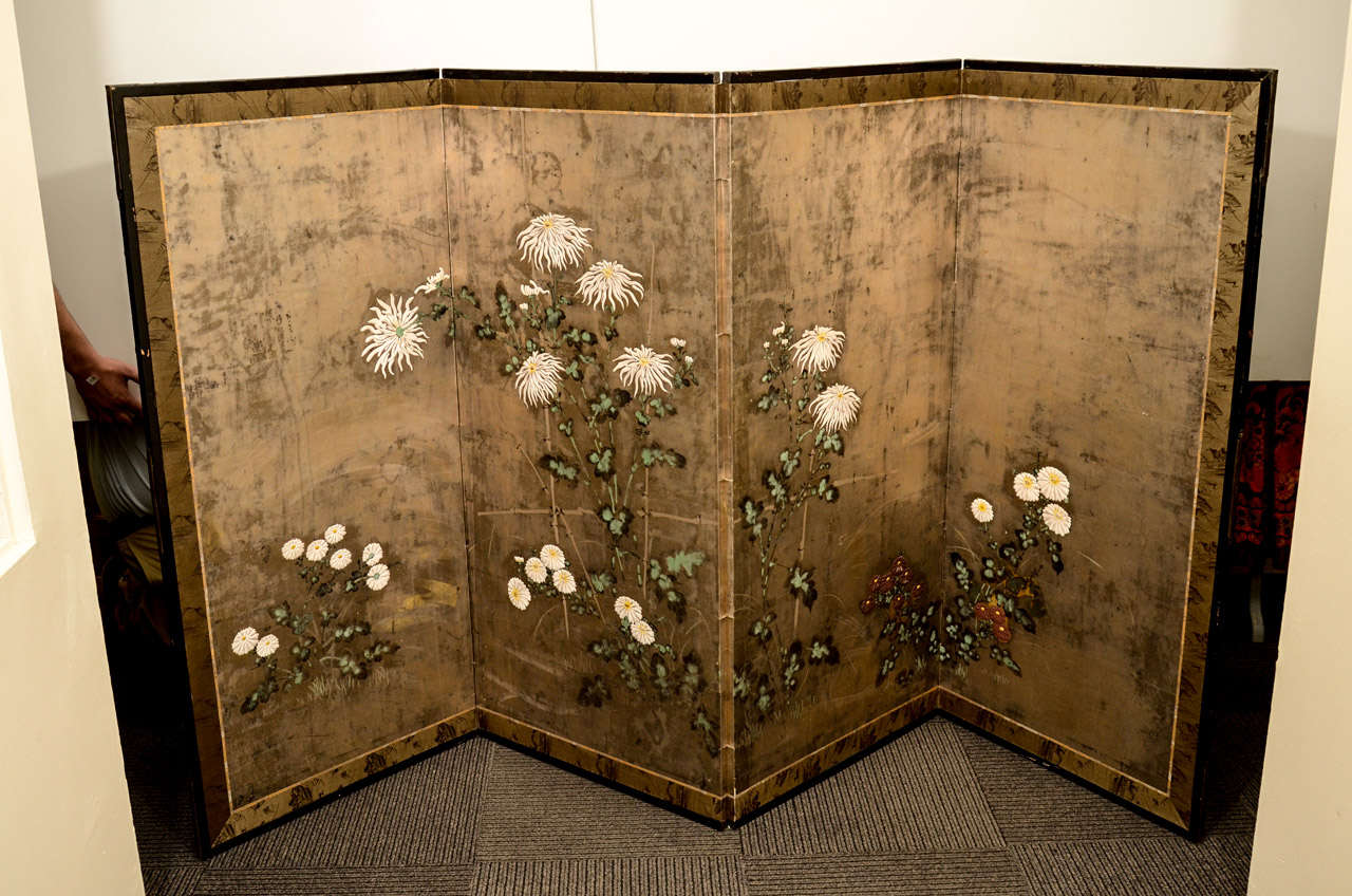 An antique Japanese four-panel folding screen from the Edo Period. The piece is decorated with flowers which are 