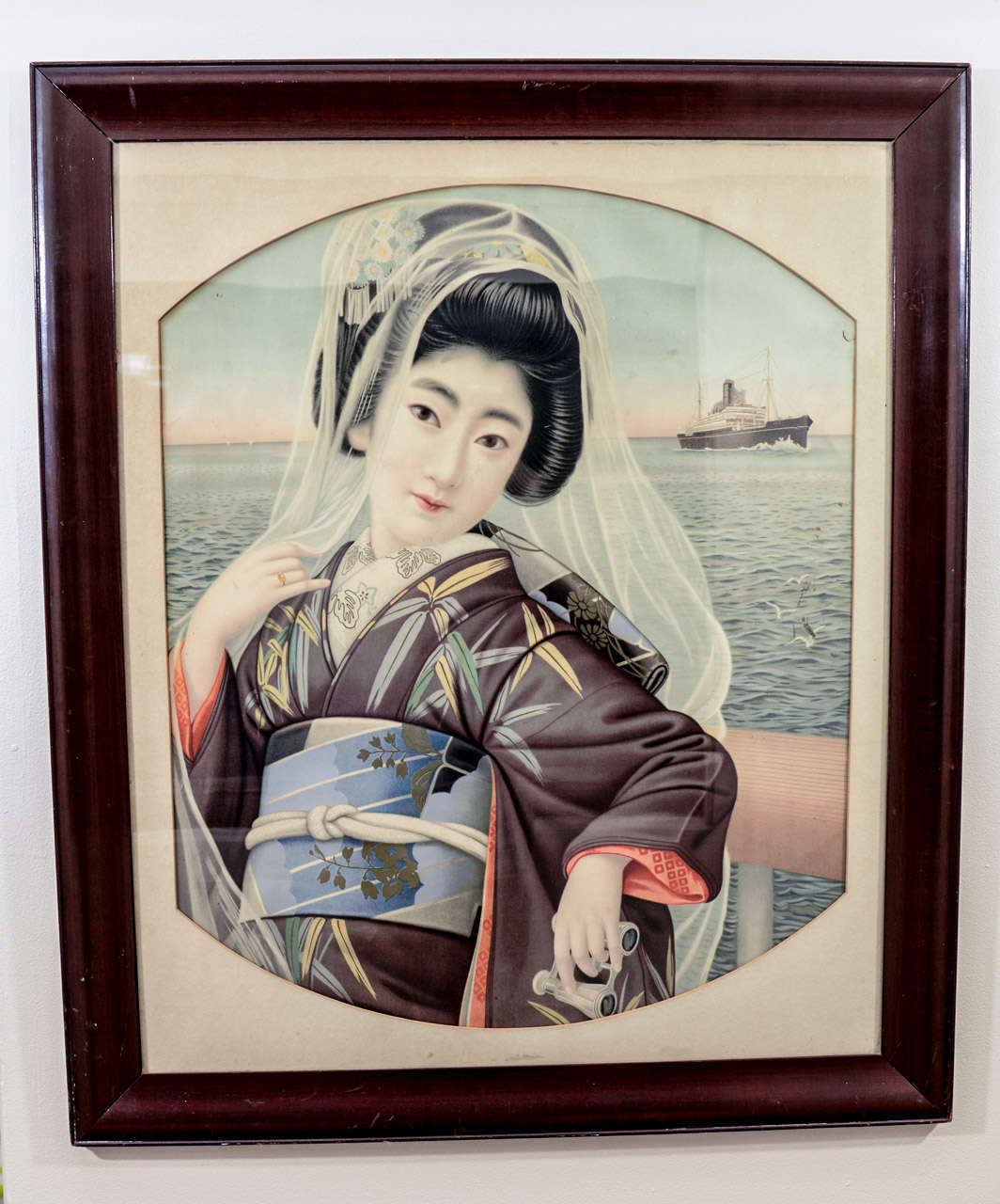 A Japanese late Meiji period portrait of a young lady standing near the ocean.