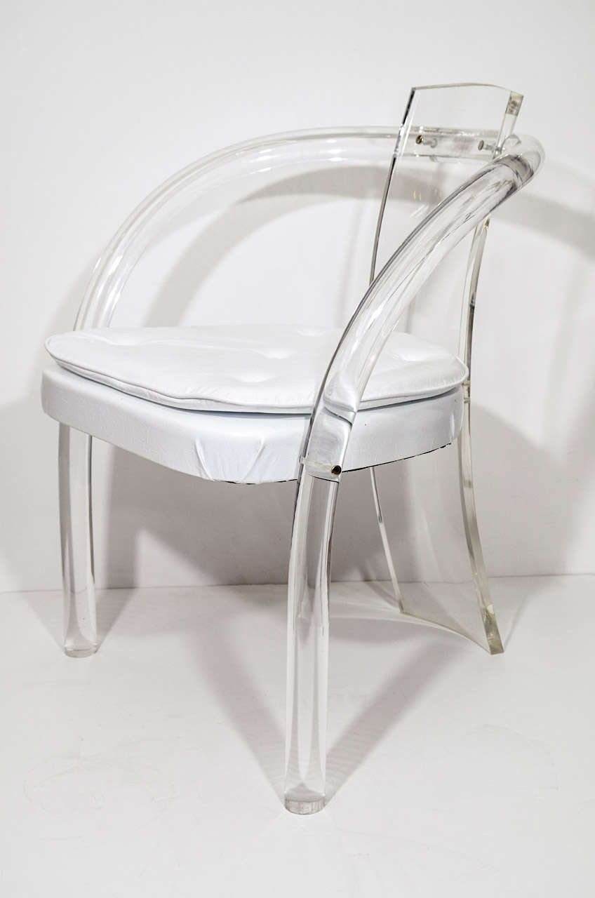 A pair of vintage lucite chairs with vinyl seats attributed to American furniture designer Charles Hollis Jones.  Jones is known for his pioneering work with Lucite. They are in good vintage condition with age appropriate wear; some scratches to