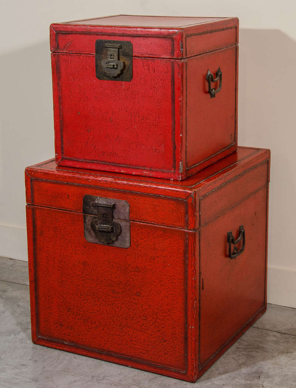Two antique Chinese red leather boxes with identical, original hardware. From Shanxi province, c. 1900.  
Small Box is Sold. 
Larger Box:  L: 16 D: 16  H: 16 = $1,150
BX501