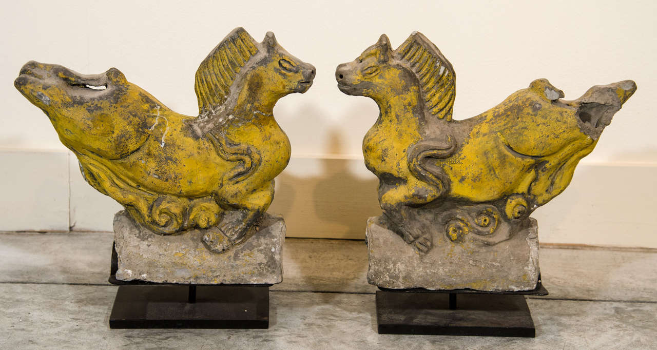 An exquisite and unusual pair of 17th Century Chinese ceramic roof tiles with original striking yellow color. Great horse Images. From Shanxi Province, c. 1650.  Custom stands included. One piece somewhat damaged at tail (see photos).  
CR381