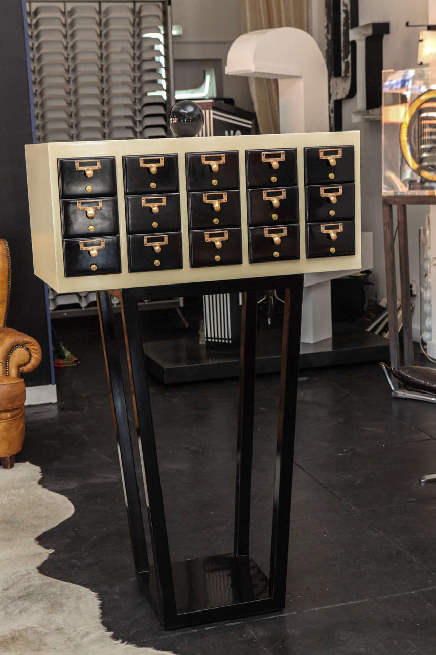 Unique Two Tone Lacquer (Black and Ivory Color) Jewelry Cabinet c. 1950's; Brass Handles; Can Be used as a Jewelry Box, Filing Cabinet, or a storage unit for any assortment of objects.