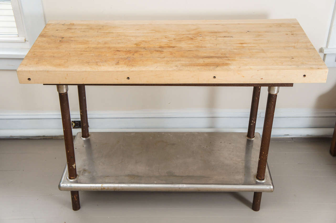 A Stainless Steel Shelf with Iron Posts Support a Large Butcher Block Top
Useful as a Small Kitchen Island or Work Surface