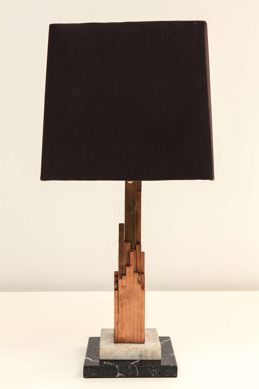 Vintage Skyscraper form table lamp made of copper, brass and marble with custom linen shade, circa 1930.