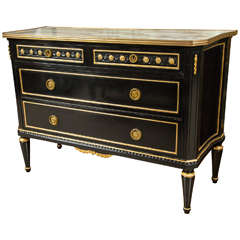 An Ebonized Commode with a Marble Top by Jansen.