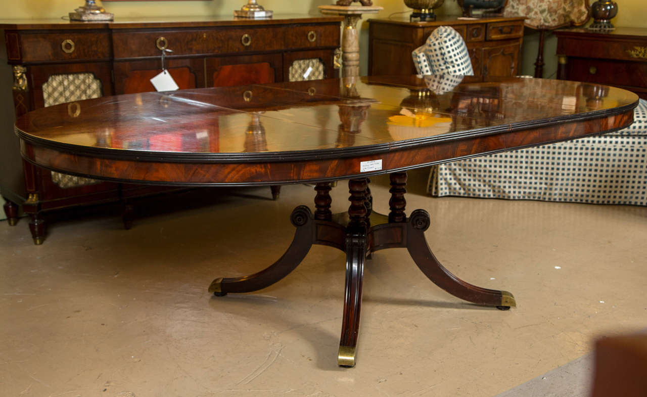 Fine Flame Solid Mahogany Dining Table by Schmieg and Kotzian. The quad legged single pedestal slides easily and effortlessly to open and close this fantastic flaming crotch mahogany table top of the finest quality. This table with three 18.25